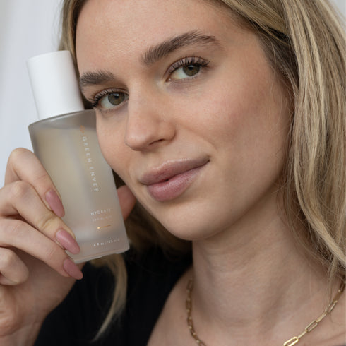 Woman with Green Envee Hydrate Facial Mist