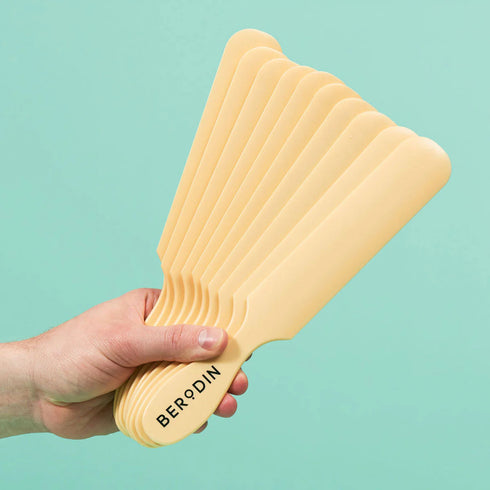 Hand holding multiple Berodin Large Plastic Spatulas
